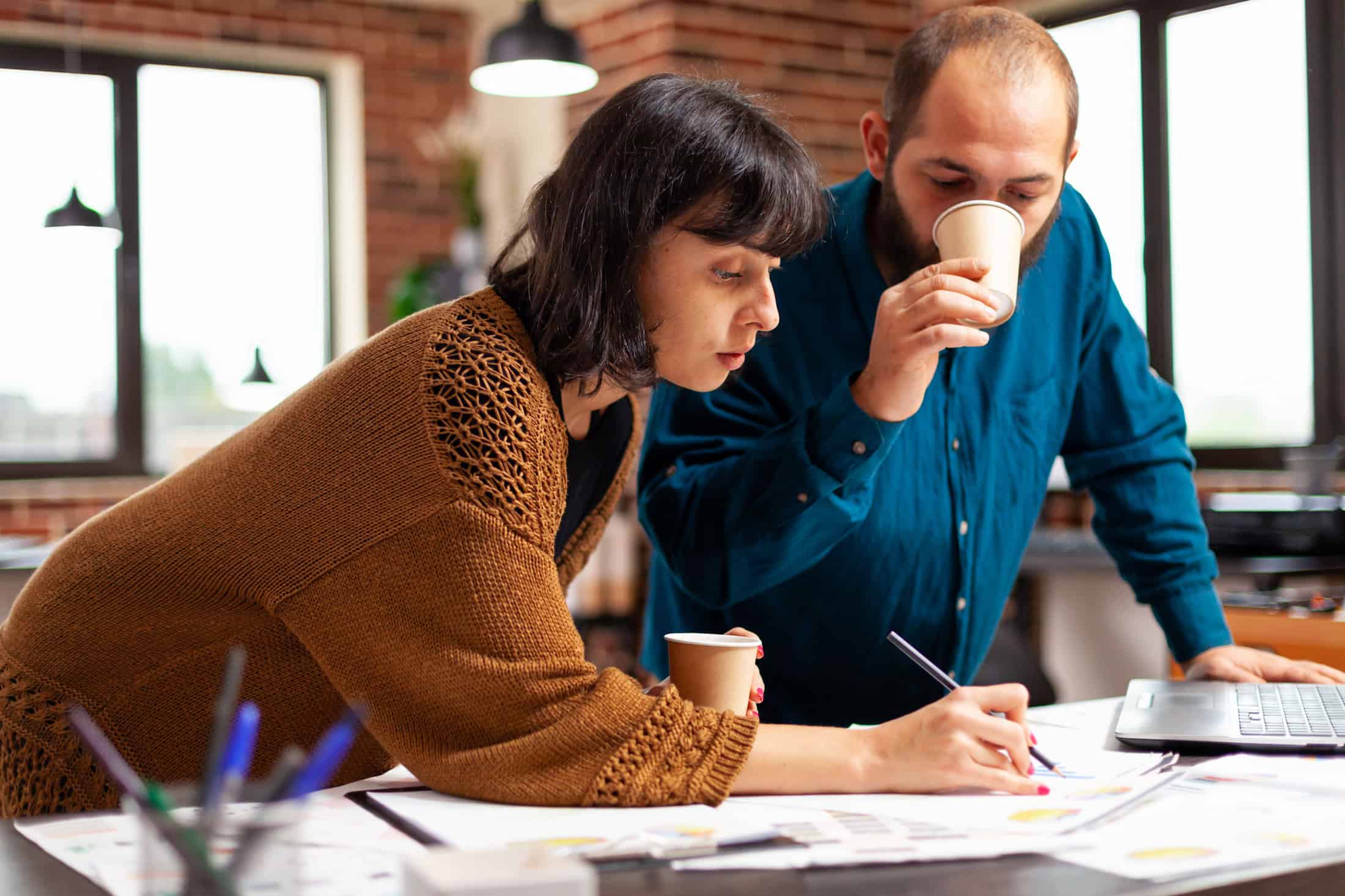 Coworkers analyzing social media metrics to improve strategy.