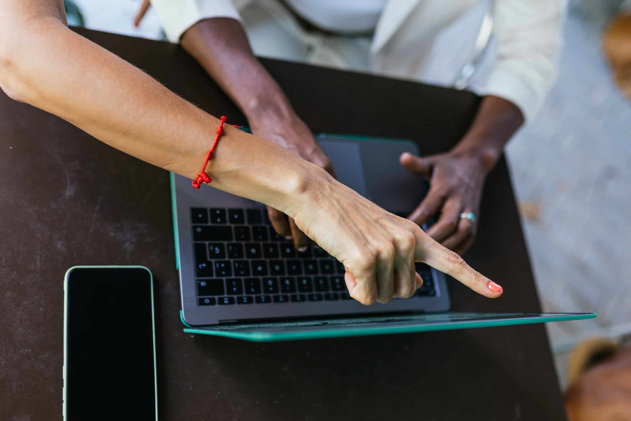 Woman pointing out changes to website.