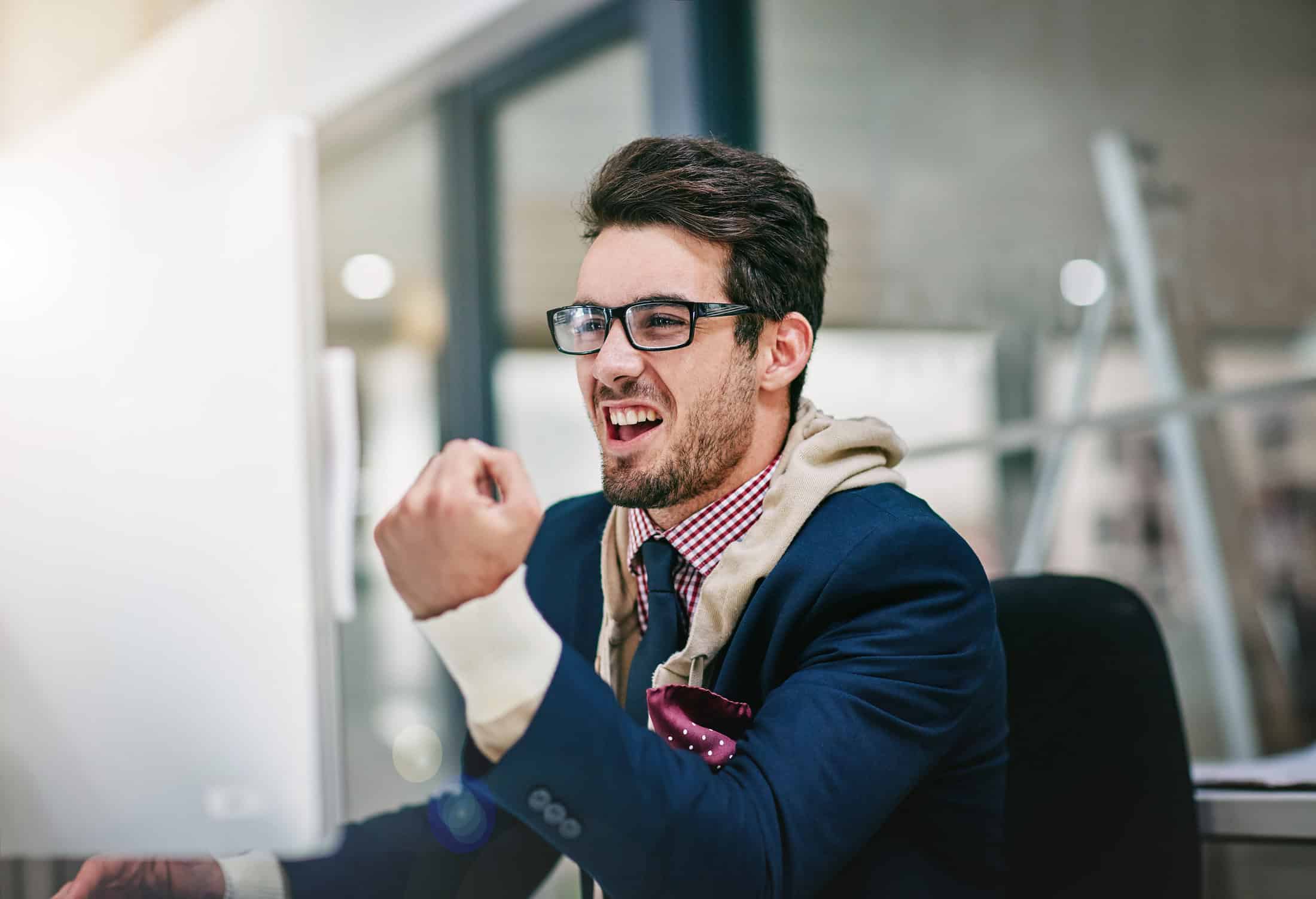 Man celebrating a customer testimonial